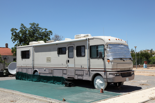 Large RV on a camping site, reversible mat